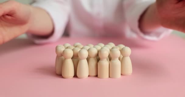 Person Covers Group Small Wooden Figurines Hands Protect Pawns Stand — Stock Video