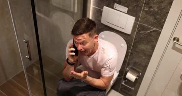 Man Talks Phone Telling Situation Secretly Hiding Toilet Premise Apartment — Stock video