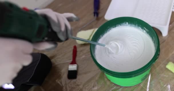 Builder Stirs White Paint Bucket Industrial Mixer Floor Room Slow — Vídeo de stock