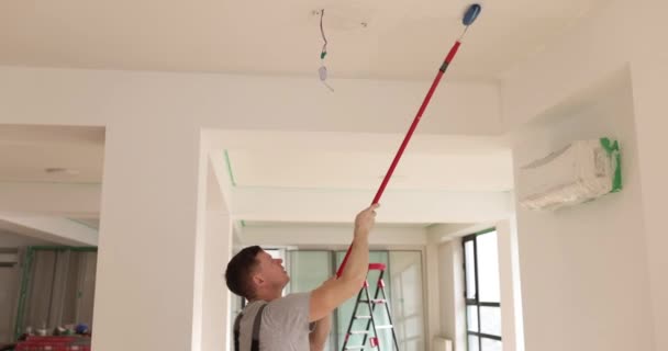 Contractor Paints Ceiling Roller Brush Long Handle Apartment Slow Motion — Stock Video