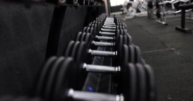 Spor salonundaki dambıllar. Güç antrenmanı konsepti için ağırlık seçimi