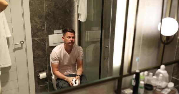 Jeune Homme Est Assis Maison Sur Les Toilettes Ennuyé Triste — Video