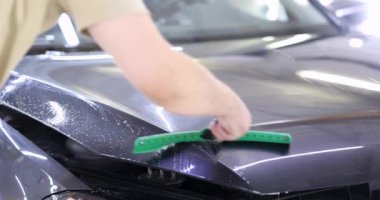 4K filmle arabanın kaputunu yıkayan adam. Araba temizleme konsepti