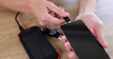Güç Bankası Solar 'ı telefona bağlayan kişi. Taşınabilir şarj Power Bank konsepti
