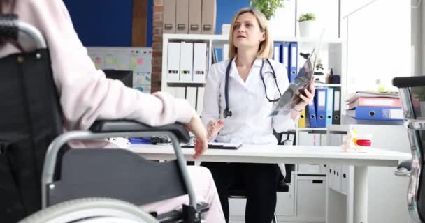 Lekarz Pokazuje Prześwietlenie Pacjentce Wózku Inwalidzkim Zbliżenie Konsultacja Chirurgów Badanie — Wideo stockowe