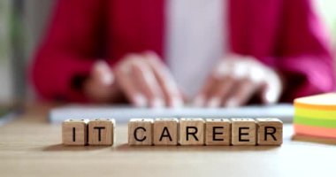 Programmer typing text on keyboard on background of word it career 4k movie slow motion. Programming concept