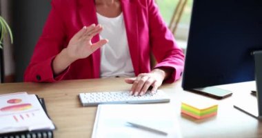 Businesswoman in pink suit waving her hand at computer screen closeup 4k movie slow motion. Business conference concept