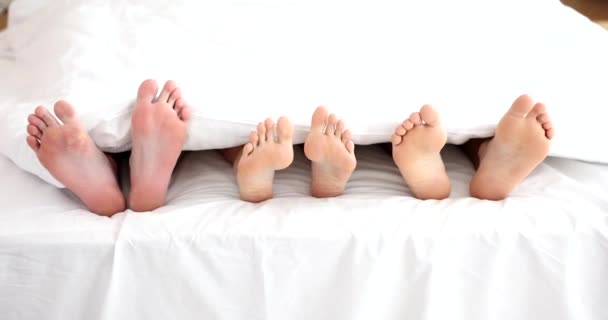 Female Two Pairs Male Legs Lying Blanket Home Movie Slow — Stockvideo