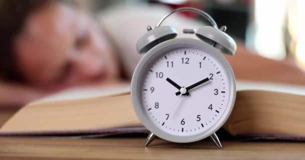 Alarm Clock Standing Table Woman Sleeping Book Closeup Movie Slow — Αρχείο Βίντεο