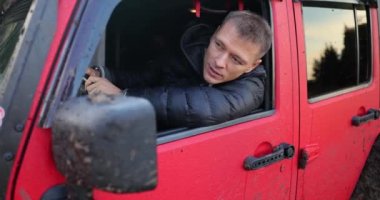 Male driver standing in traffic jam on car and looking through window 4k movie slow motion. Problems on road in countryside concept
