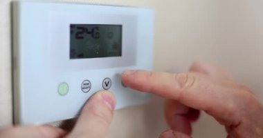 Male hand adjusting temperature on air conditioner closeup 4k movie slow motion. Comfortable temperature at home concept