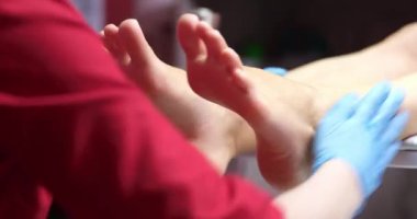 Podiatrist making foot massage of female patient in clinic closeup 4k movie slow motion. Quality professional pedicure concept