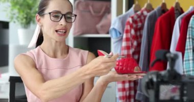 Woman blog records video review on women sandals. Online channel for selling shoes concept