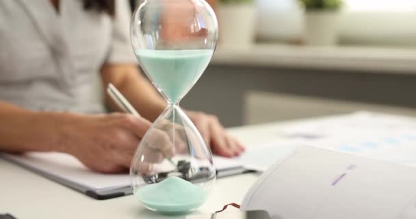 Woman Fills Out Paperwork Background Hourglass Workplace Time Management Deadline — Stock Video