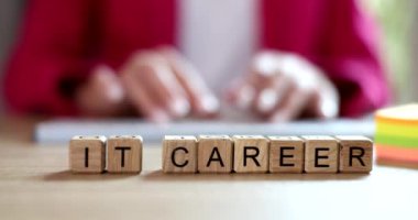 Words IT career on wooden cubes and IT specialist training. Career and work in the field of information technology