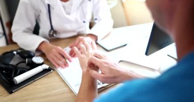 Dermatologist examines skin of hand with itching of sick patient. Examination and diagnosis of skin diseases allergies psoriasis, eczema and dermatitis