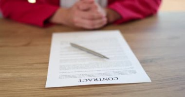 Business woman sits at office desk and waits to sign contract. Business agreement loan and lease or partnership