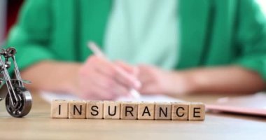 Agent or client fills out auto or motorcycle insurance form. Car insurance deal and warranty