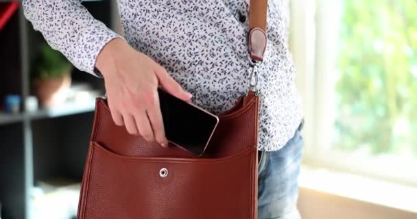 Woman Puts Smartphone Brown Leather Bag Mobile Data Security Your — Stockvideo
