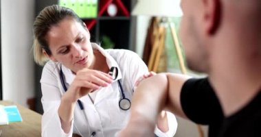 Dermatologist looks at skin of man hands with magnifying glass. Eczema causes symptoms and treatment