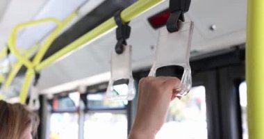 People hold hand on train or bus. Safety in public transport