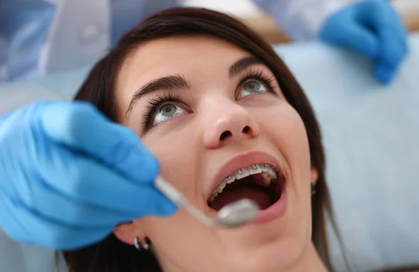 stock image A woman at the reception of a male dentist examining teeth and oral cavity