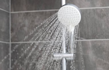 Shower mixer from which water flows into bathroom. Contrast shower benefits for the body concept clipart