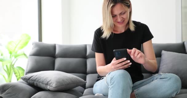 Usmívající Dívka Relaxuje Sedí Doma Pohovce Pomocí Mobilního Telefonu Chatuje — Stock video