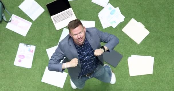 商人在摇摇欲坠的文书工作和地板上的笔记本电脑之间跳舞 执行经理表现出滑稽的舞步 表情激动 动作慢 动作快 动作快 — 图库视频影像