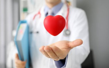 Doktor dosyaları tutarken kalbi yakalar. Yüksek tansiyon. Kardiyovasküler hastalığı önleme. Kalp için sağlıklı beslenme prensiplerine bağlı kal. Başarılı kurulum kalp pili