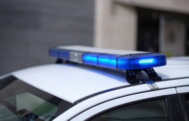 Closeup of blue lights on roof of police car. Flashing beacons of police car and arrest of criminal