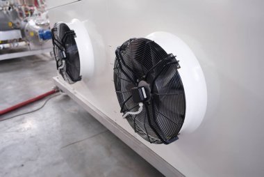 Cooling industrial air conditioners and fans closeup. Maintenance of ventilation systems concept