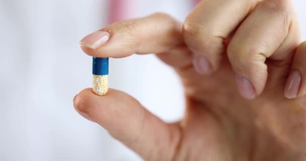 Woman Doctor Hand Holds Capsule Containing Vitamins Improve Physical Health — Stock Video