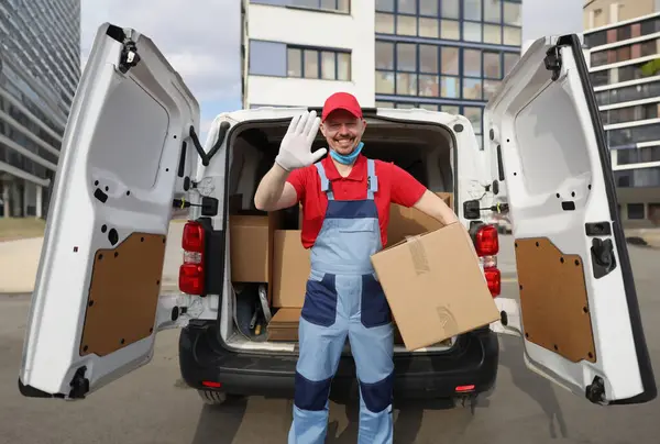 Handsome Courier Takes Cardboard Box Out Van Waves Welcome Courier — Stock Photo, Image