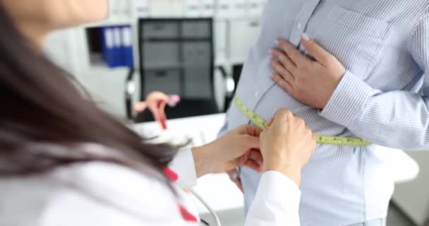 在诊所咨询妇科医生和带医生的孕妇 测量腹部周长和怀孕的特征 — 图库视频影像