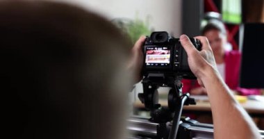 Cameraman filming on professional camera businesswoman in office 4k movie slow motion. Blogging concept
