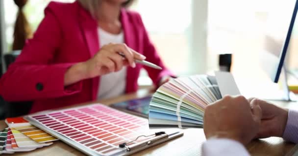 Designer Helping Client Choose Color Using Swatch Fan Closeup Movie — Stock Video