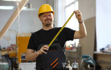 Yakışıklı işçi ölçme. El ile iş DIY ilham iyileştirme iş düzeltme Dükkanı sarı kask sanayi startu işyeri fikir tasarımcı kariyer cetvel endüstriyel eğitim