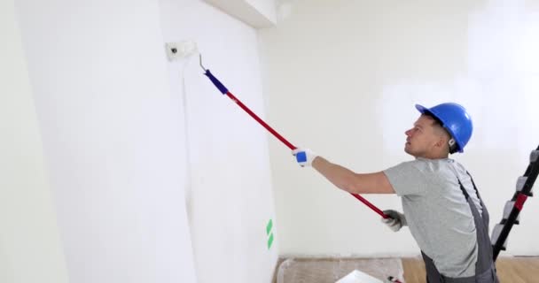 Builder Overalls Paints Wall Hallway Uses Roller Repair Redecoration — Stock Video