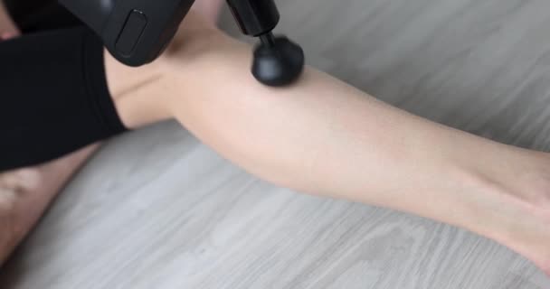 女人用打击乐按摩器4K片按摩腿 缓解肌肉痉挛的概念 — 图库视频影像