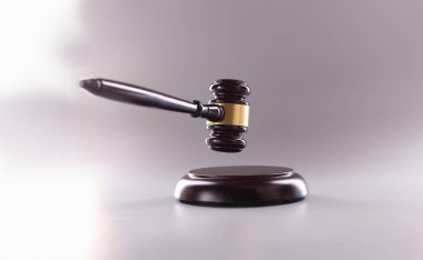 Wooden gavel for court or auction on gray background.Symbol of power and the right to perform competent actions in position of judge