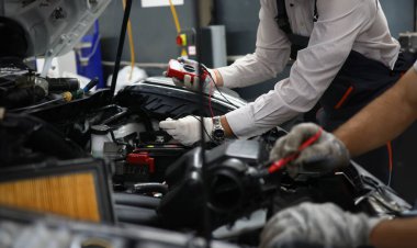 Car repair technicians use voltage multimeter to work in auto repair shops. Diagnostics of car engine breakdowns