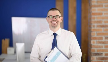 Portrait of young smiling businessman in glasses in office. Business consultant manager concept