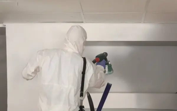 Worker Paints Wall White Spray Gun Painter Protective Suit Spray — Photo