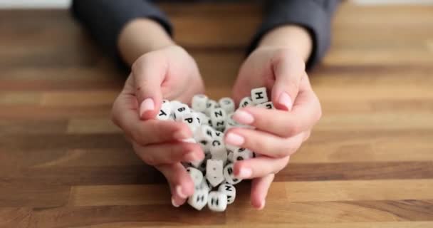 Female Hands Louring Out Cubes English Alphabet Close Seup Movie — стоковое видео