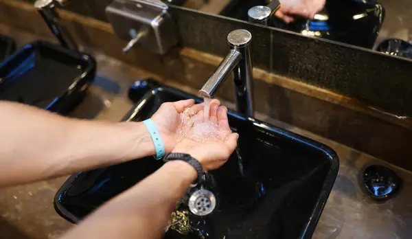 Washing hands in sink. Clean hands guarantee health concept