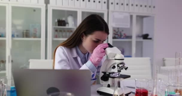 Výzkumnice Dívá Biologické Vzorky Pod Mikroskopem Zapisuje Výsledky Výzkumu Notebooku — Stock video