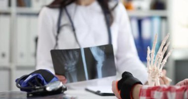 Doctor examined patient with pain in wrist and x-ray of hand. Wrist injury treatment sprain dislocation concept