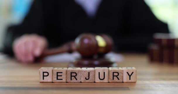 Word Perjury Constructed Wooden Cubes Judge Knocking Wooden Gavel Intentional — Stock Video