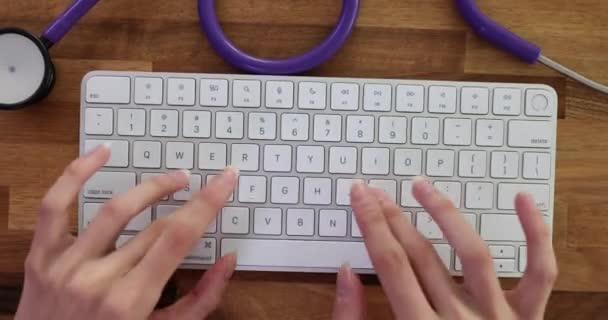 Woman Typing Computer Keyboard Table Medical Stethoscope Lady Doctor Entering — Stock Video
